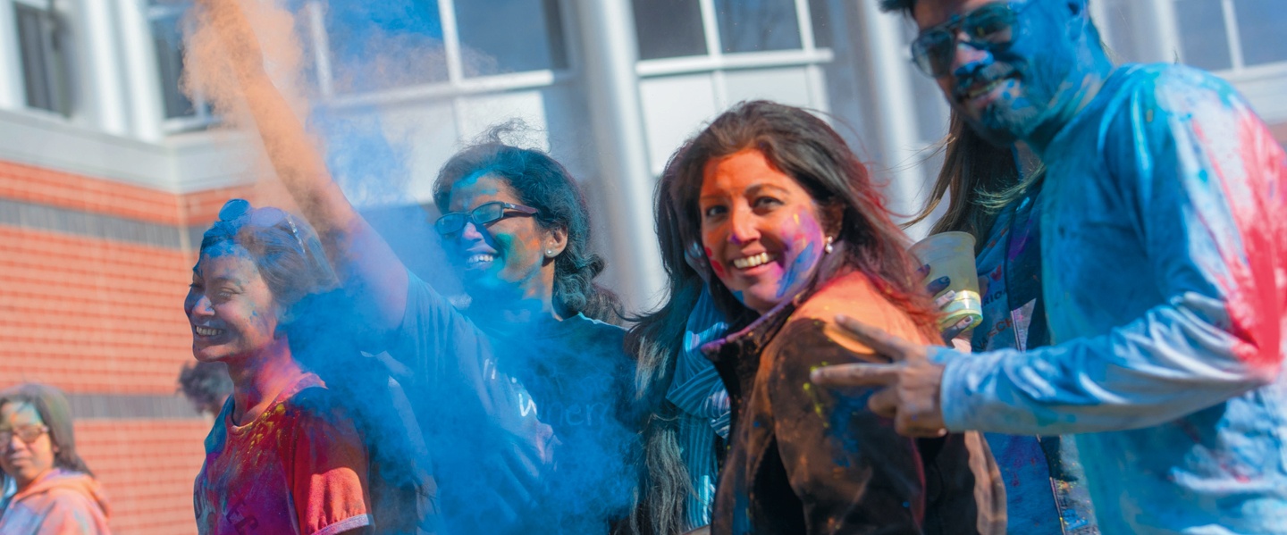 Students and faculty celebrating Holi Festival on campus